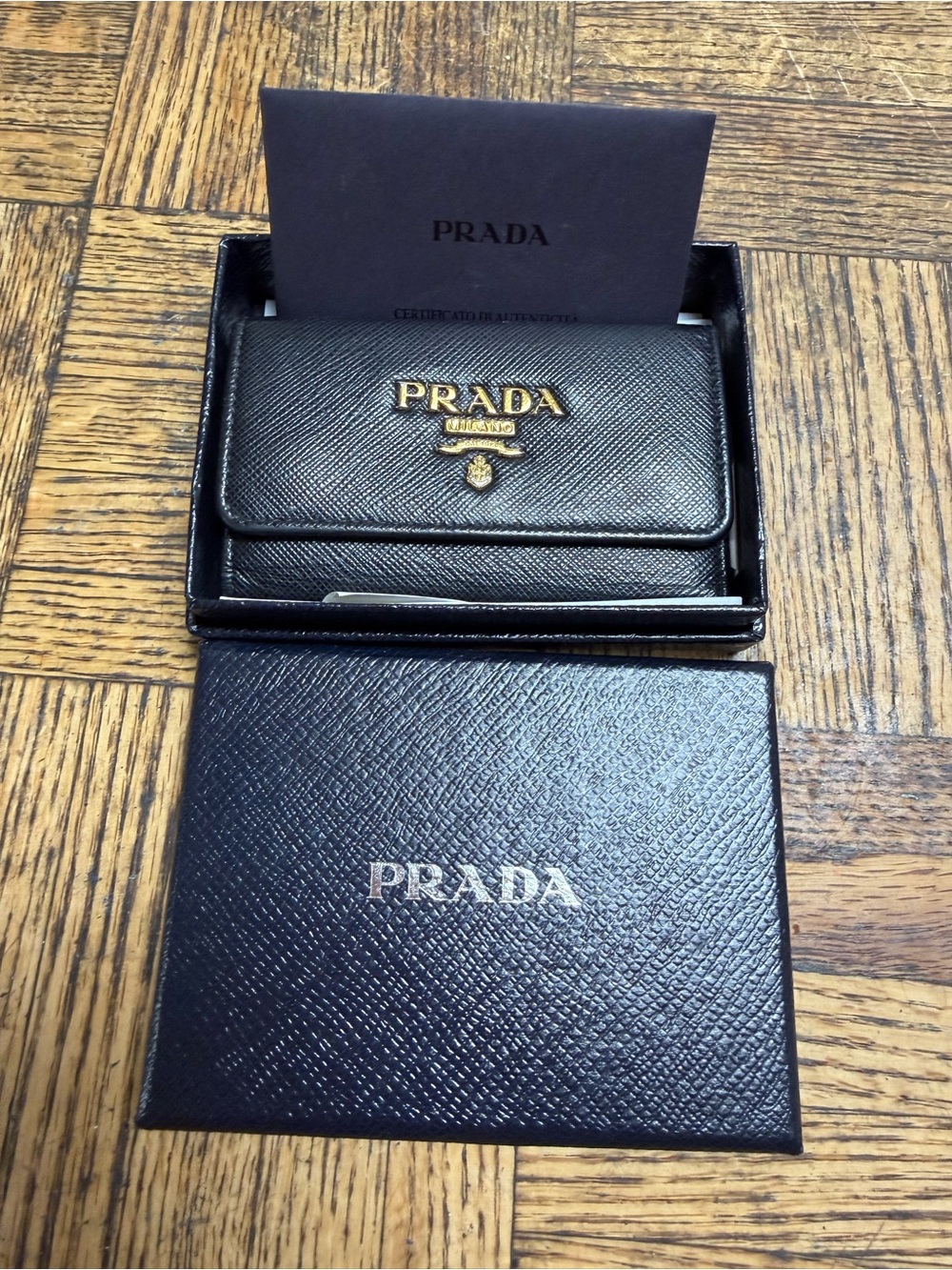 Prada Black Saffiano Leather Trifold Wallet with Gold Logo key holder